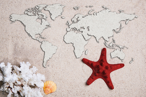  Map of the world. Traveling concept. Starfish with coral on the Beach sand