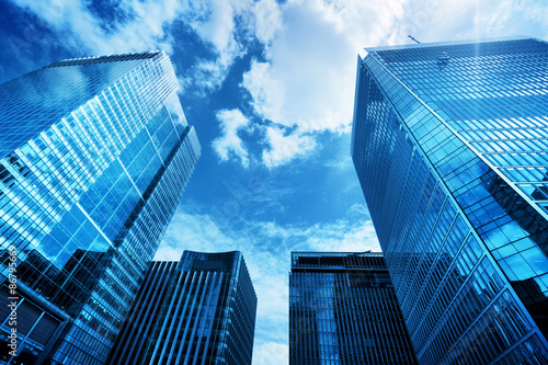 Modern business skyscrapers, high-rise buildings, architecture raising to the sky, sun