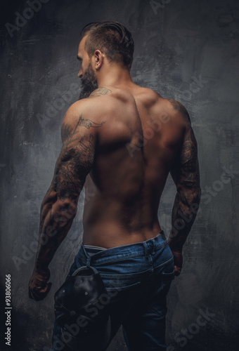 Shirtless muscular guy from back.
