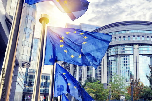 EU flags waving in front of European Parliament building in Brus