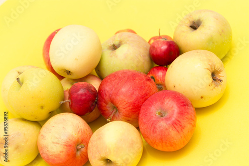 ripe apples on a yellow background