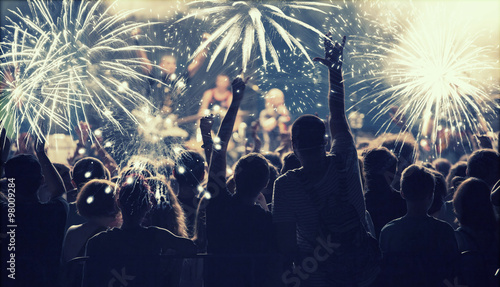 New Year concept - cheering crowd and fireworks