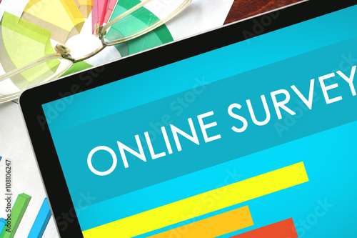Online Survey written on a tablet. Web marketing concept.