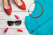red shoes and dress with a necklace and nail Polish on white wooden background red shoes and dress with a necklace and nail Polish on white wooden background