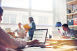 Team work process. Young business crew in big loft office. Laptop with graph, analysing marketing. Film effect, blurry background, lens flare effect Team work process. Young business crew in big loft office. Laptop with graph, analysing marketing. Film effect, blurry background, lens flare effect