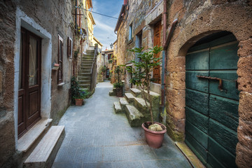 Spring streets of the old Tuscan town. Colorful flowers bloom
