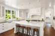 Beautiful White Kitchen in New Luxury Home with Lights On Beautiful White Kitchen in New Luxury Home with Lights On