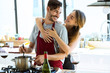 Happy young couple cooking together in the kitchen at home. Happy young couple cooking together in the kitchen at home.