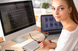 Young woman working in office, sitting at desk Young woman working in office, sitting at desk