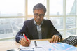 senior business man working on office table senior business man working on office table