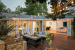 Home with furniture patio / wooden deck at twilight. Home with furniture patio / wooden deck at twilight.