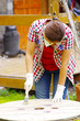 woman with handgloves painting a wood table woman with handgloves painting a wood table