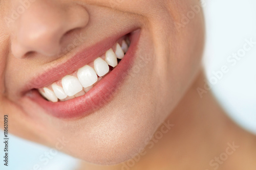 Closeup Of Beautiful Smile With White Teeth. Woman Mouth Smiling. High Resolution Image © puhhha