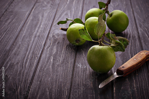 Green apples on wooden background