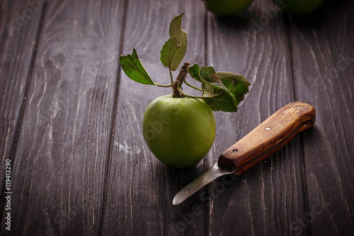 Green apples on wooden background