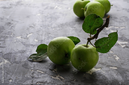 Green apples on wooden background