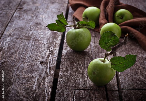Green apples on wooden background