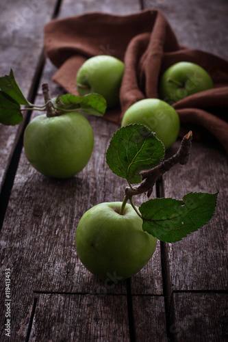 Green apples on wooden background
