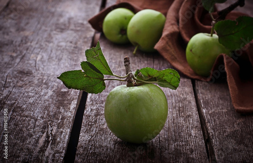 Green apples on wooden background