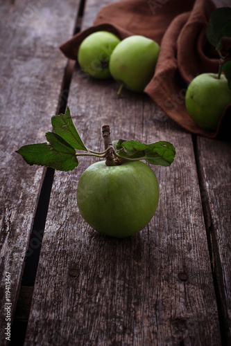 Green apples on wooden background