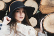 Gorgeous young woman in autumn outfit posing next to tree chunks Gorgeous young woman in autumn outfit posing next to tree chunks