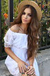 beautiful woman with dark curly hair and bright makeup in elegant dress beautiful woman with dark curly hair and bright makeup in elegant dress