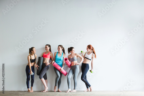 Smiling women in fitness studio. © BestForYou