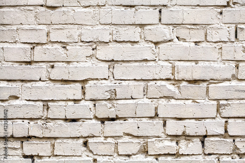 Weathered stained white brick wall, texture grunge background