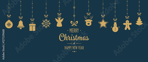 gold christmas ornament hanging blue background