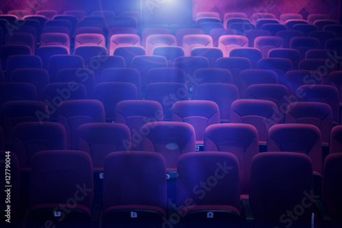 Empty movie theater with projection light falling into the lens