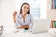 Businesswoman holding glasses sitting and using laptop Businesswoman holding glasses sitting and using laptop