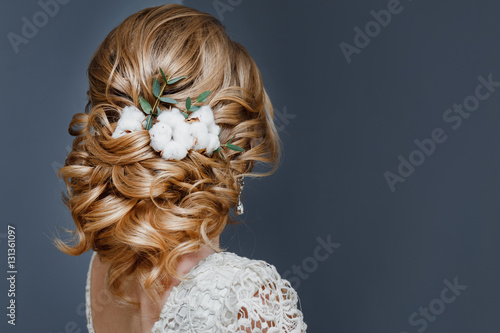 Fototapeta beauty wedding hairstyle decorated with cotton flower, rear view
