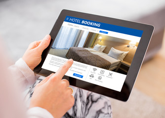 Person booking hotel room on tablet