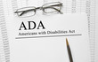 Paper with Americans with Disabilities Act (ADA) on a table Paper with Americans with Disabilities Act (ADA) on a table