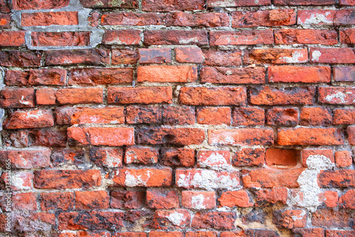 Red cracked old brick wall texture background.