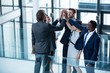 Businesspeople giving high five to each other Businesspeople giving high five to each other