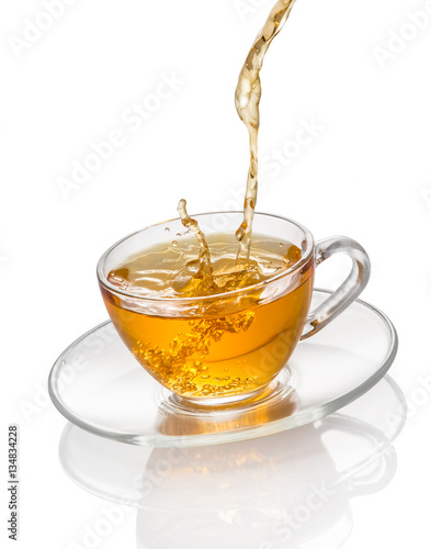 Tea flowing in cup