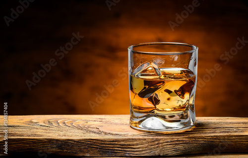 whiskey with ice on a wooden table