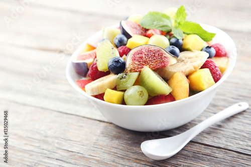 Fresh fruit salad on a grey wooden table
