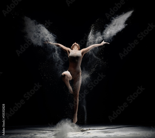 Obraz Fotograficzny Slender girl dancing in white powder cloud