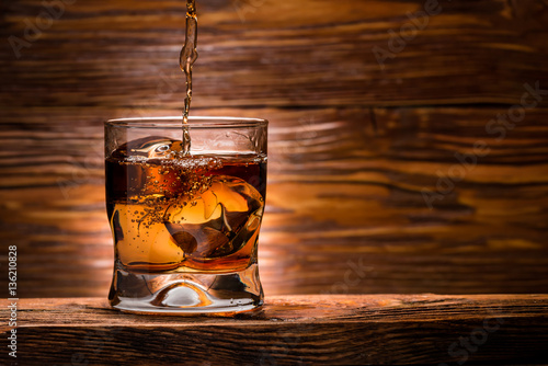 whiskey with ice on a wooden table