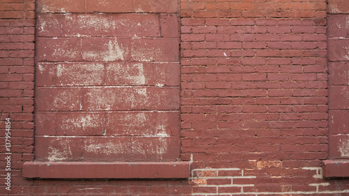 Red brick wall with blocked window