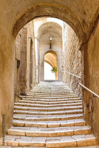 old stone steps and arch in the medieval village, Pitigliano, tuscany, italy