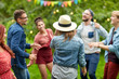 happy friends dancing at summer party in garden happy friends dancing at summer party in garden