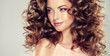 Beautiful model girl with wavy hairstyle . Brunette woman with long curly hair Beautiful model girl with wavy hairstyle . Brunette woman with long curly hair