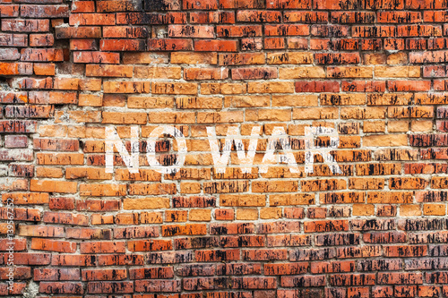 Text NO WAR on stained old orange brick wall texture background