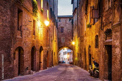 Fototapeta na wymiar Night old streets in medieval Siena, Tuscany region, Italy.