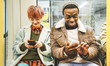 Multiracial hipster friends couple having fun with smartphone in subway train - Urban relationship concept with young people watching mobile phone in city underground area - Bright desaturated filter Multiracial hipster friends couple having fun with smartphone in subway train - Urban relationship concept with young people watching mobile phone in city underground area - Bright desaturated filter