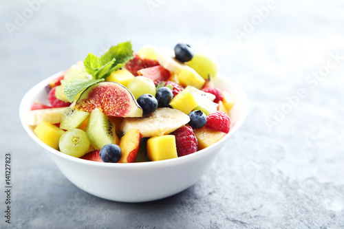 Fresh fruit salad on a grey wooden table