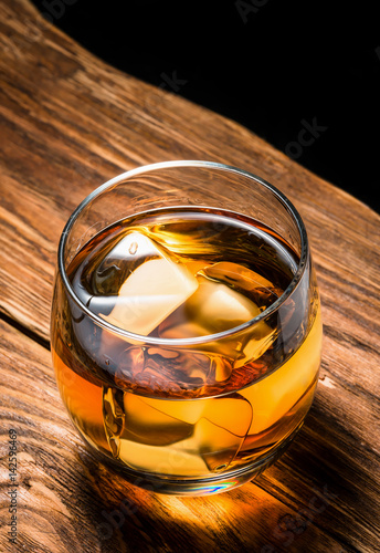 whiskey with ice on a wooden table